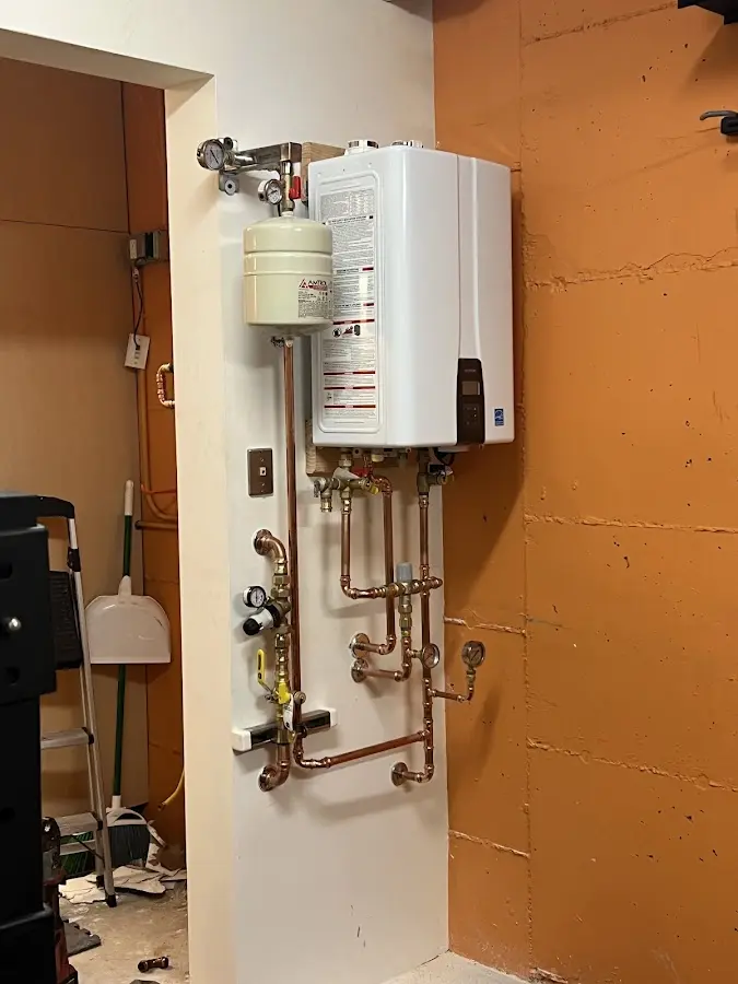 Plumbing technician inspecting water heater connections in Leesville